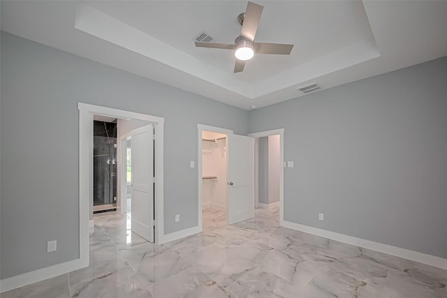 403 Smith St, Dayton, TX 77535 - unfurnished bedroom with baseboards, visible vents, a spacious closet, and a raised ceiling