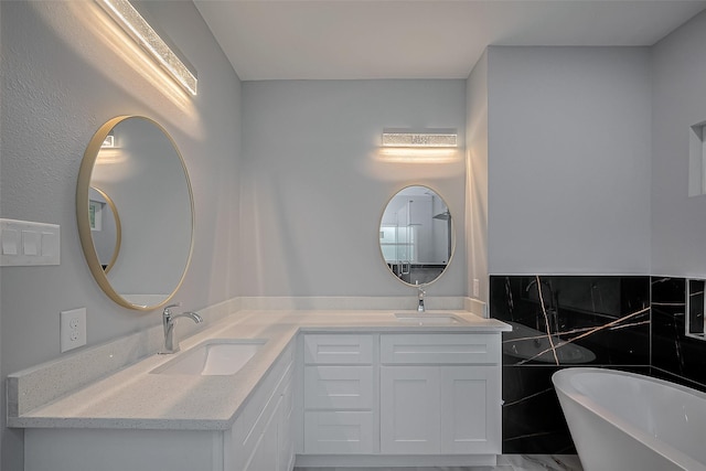 403 Smith St, Dayton, TX 77535 - full bathroom with double vanity, a freestanding bath, a sink, and marble finish floor