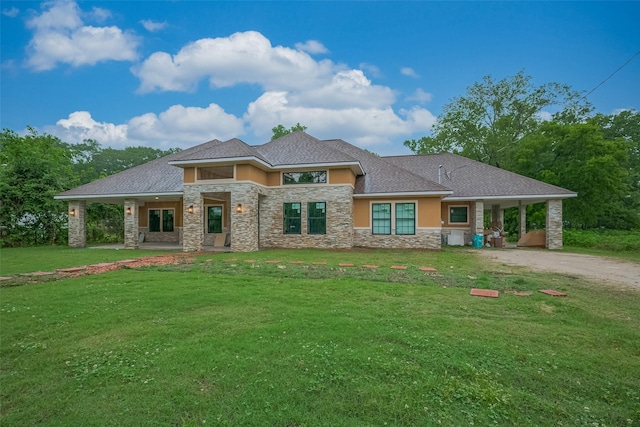 403 Smith St, Dayton, TX 77535 - prairie-style home with a front yard, driveway, stone siding, and stucco siding