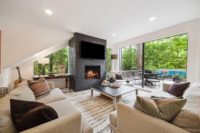 living area featuring recessed lighting and a fireplace