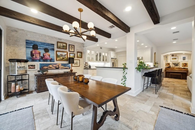 dining space featuring visible vents, recessed lighting, stone tile flooring, and an inviting chandelier
