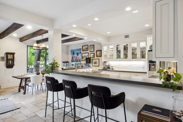 bar with recessed lighting, baseboards, visible vents, and stone tile flooring