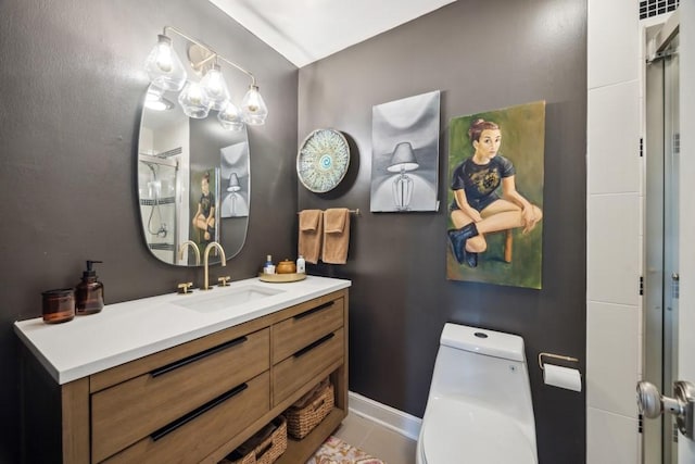 bathroom featuring toilet, baseboards, a shower stall, and vanity