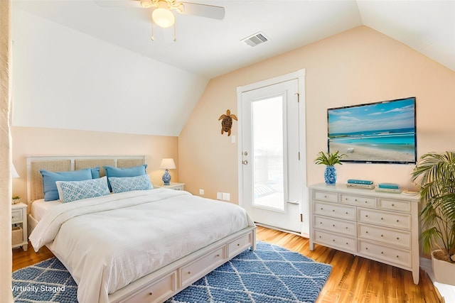 bedroom with visible vents, wood finished floors, ceiling fan, and lofted ceiling