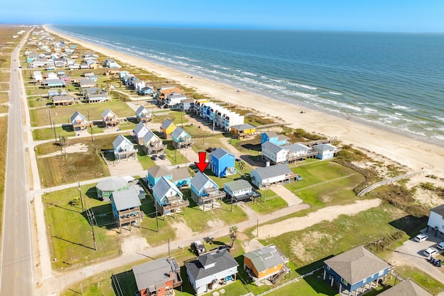 birds eye view of property featuring a beach view, a residential view, and a water view