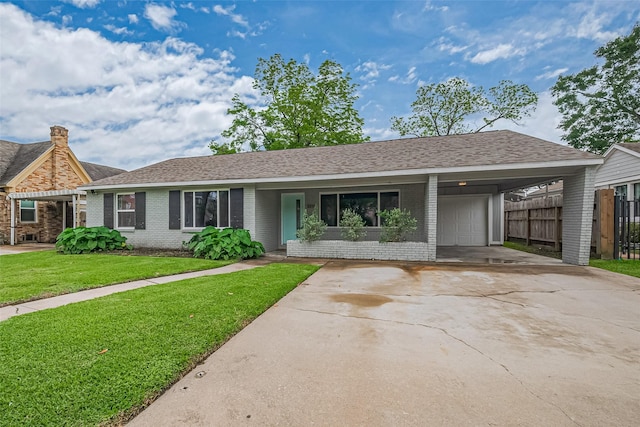 single story home with brick siding, fence, a front yard, concrete driveway, and an attached garage