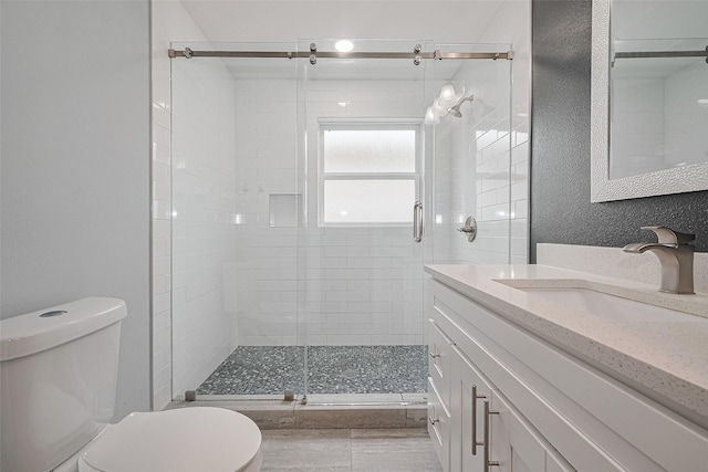 full bath with a shower stall, toilet, and vanity