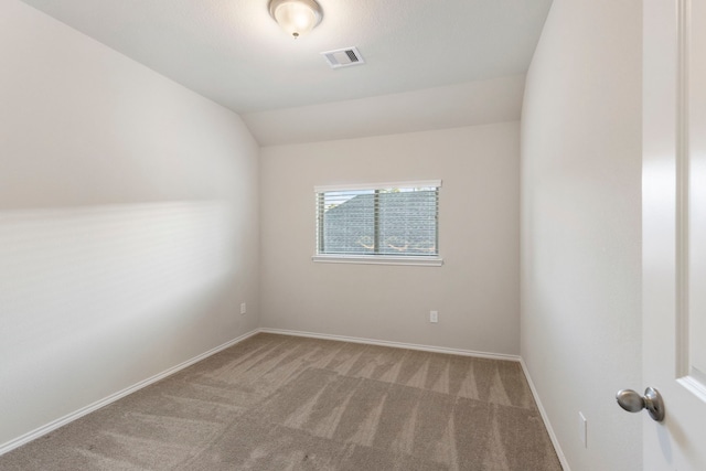 549 Timber Voyage Ct, Conroe, TX 77304 - spare room featuring visible vents, carpet, baseboards, and vaulted ceiling