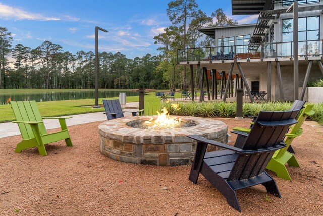 549 Timber Voyage Ct, Conroe, TX 77304 - view of yard featuring stairway, a deck with water view, and an outdoor fire pit
