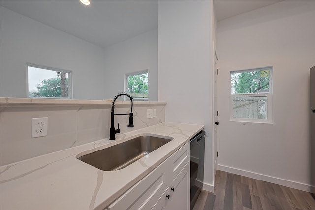9003 Hilda St, Houston, TX 77033 - kitchen with a sink, dishwashing machine, dark wood-style floors, light stone countertops, and white cabinetry
