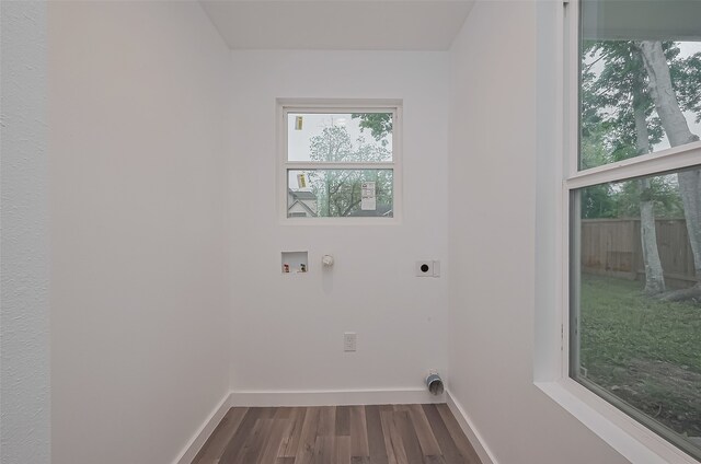 9003 Hilda St, Houston, TX 77033 - laundry room featuring hookup for an electric dryer, dark wood-style flooring, baseboards, and hookup for a washing machine