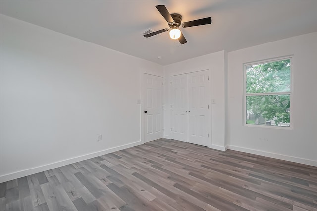 9003 Hilda St, Houston, TX 77033 - unfurnished bedroom with wood finished floors, baseboards, a ceiling fan, and a closet