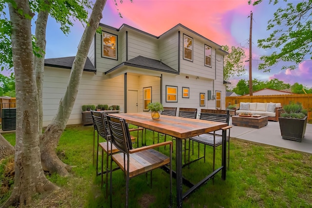 9003 Hilda St, Houston, TX 77033 - rear view of house with an outdoor living space with a fire pit, a patio area, a shingled roof, and outdoor dining area