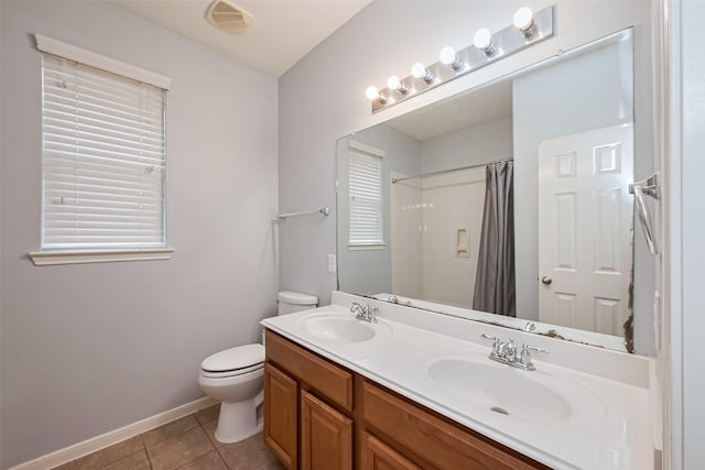 1839 Pembrook Cir, Conroe, TX 77301 - bathroom featuring toilet, a sink, tile patterned floors, and baseboards