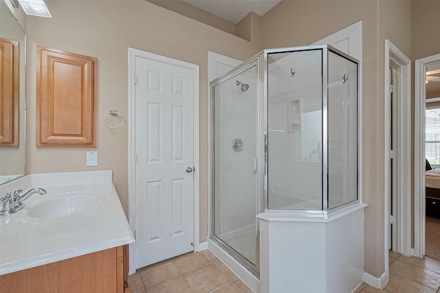 1839 Pembrook Cir, Conroe, TX 77301 - ensuite bathroom featuring a stall shower, tile patterned flooring, a sink, and ensuite bath