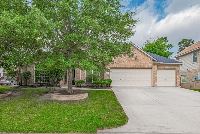 1839 Pembrook Cir, Conroe, TX 77301 - view of property hidden behind natural elements with brick siding, a shingled roof, driveway, a front lawn, and an attached garage