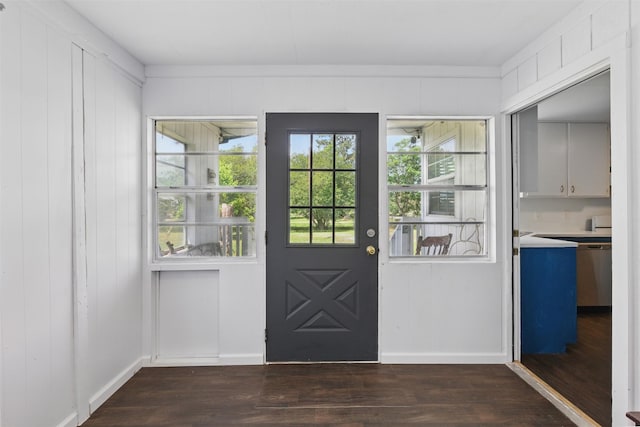 entryway with dark wood-style floors and baseboards