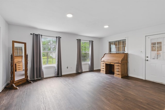 unfurnished living room with dark wood finished floors, baseboards, and recessed lighting