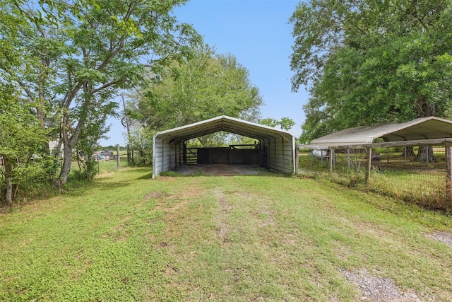 view of yard with a carport and driveway
