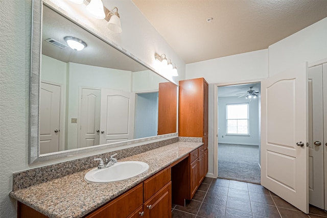 bathroom with tile patterned floors, visible vents, vanity, and ceiling fan