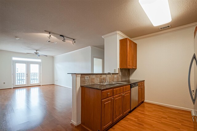 kitchen featuring brown cabinets, light wood finished floors, and a sink