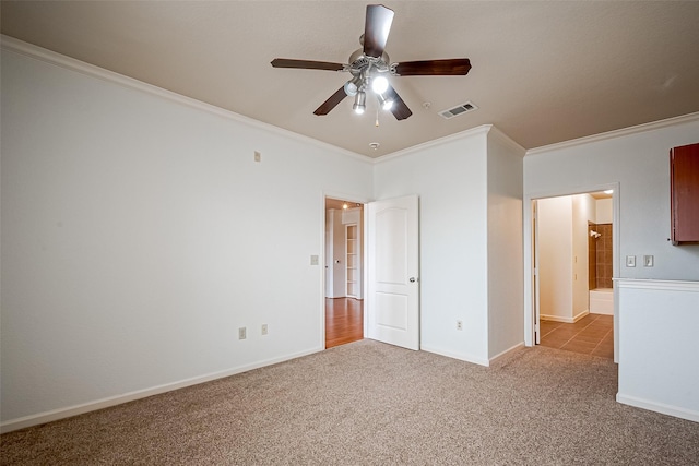 unfurnished bedroom featuring ceiling fan, crown molding, visible vents, carpet, and baseboards