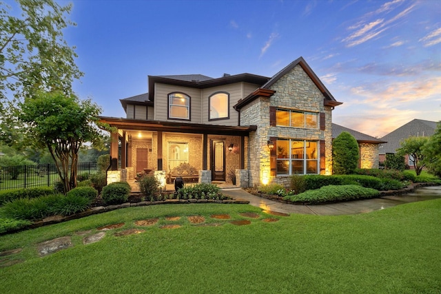 36927 Anglers Way, Pinehurst, TX 77362 - back of house at dusk with stone siding and a porch