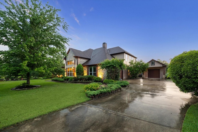 36927 Anglers Way, Pinehurst, TX 77362 - view of front of home with a front lawn, stone siding, driveway, a chimney, and a garage