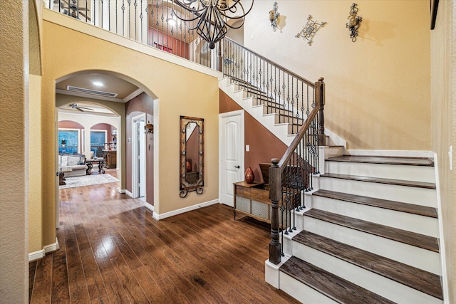 36927 Anglers Way, Pinehurst, TX 77362 - entryway with arched walkways, baseboards, stairway, wood-type flooring, and a chandelier