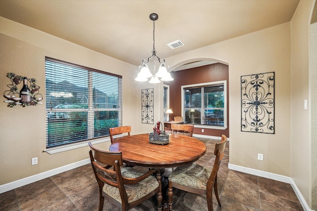 36927 Anglers Way, Pinehurst, TX 77362 - dining room with arched walkways, a chandelier, and baseboards