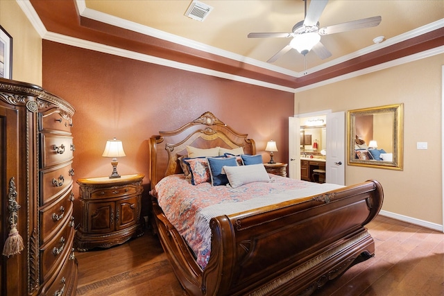 36927 Anglers Way, Pinehurst, TX 77362 - bedroom with hardwood / wood-style floors, crown molding, a tray ceiling, baseboards, and ensuite bath
