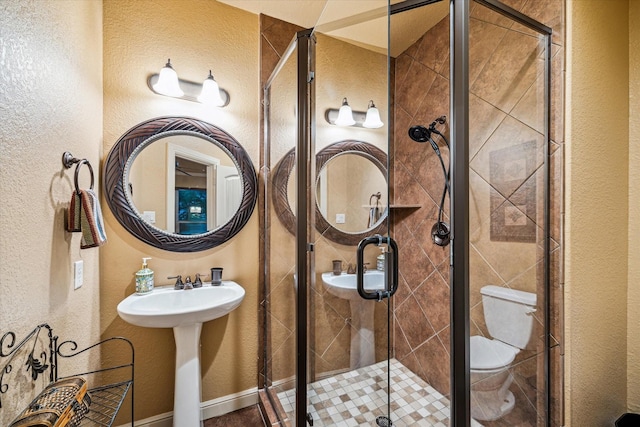 36927 Anglers Way, Pinehurst, TX 77362 - bathroom featuring a textured wall, a stall shower, and a sink