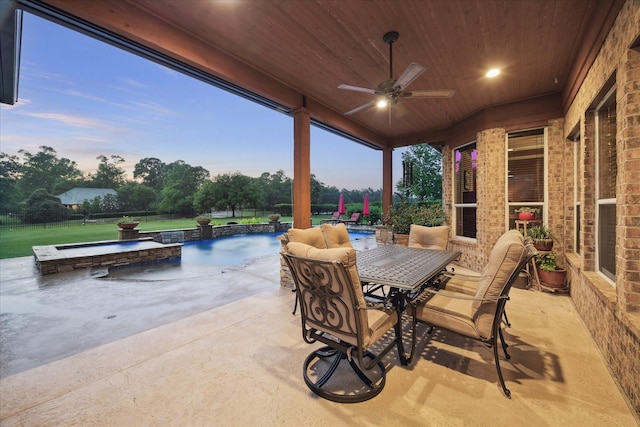 view of patio with a ceiling fan, an outdoor pool, outdoor dining area, and fence