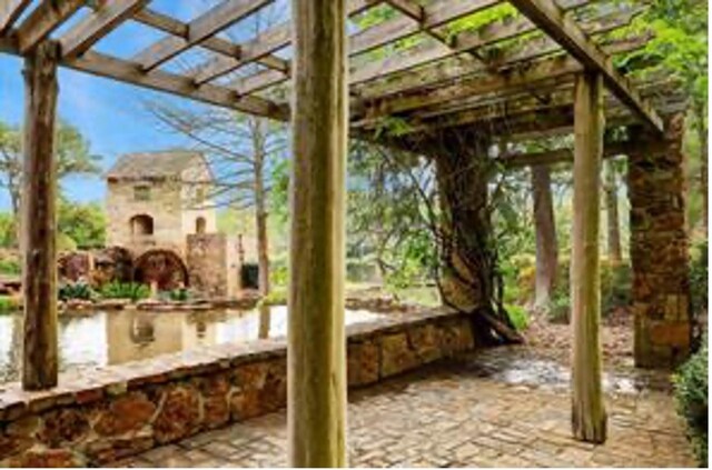 36927 Anglers Way, Pinehurst, TX 77362 - view of patio / terrace featuring a pergola and a water view