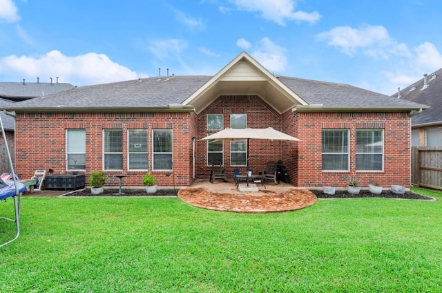 1619 Julia Park Dr, Spring, TX 77386 - rear view of property with a trampoline, a patio, brick siding, and a shingled roof