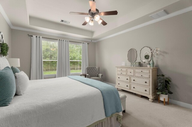 carpeted bedroom with baseboards, visible vents, ceiling fan, and a raised ceiling