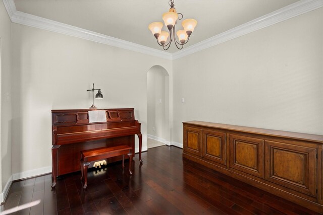 sitting room featuring baseboards, arched walkways, dark wood finished floors, and ornamental molding