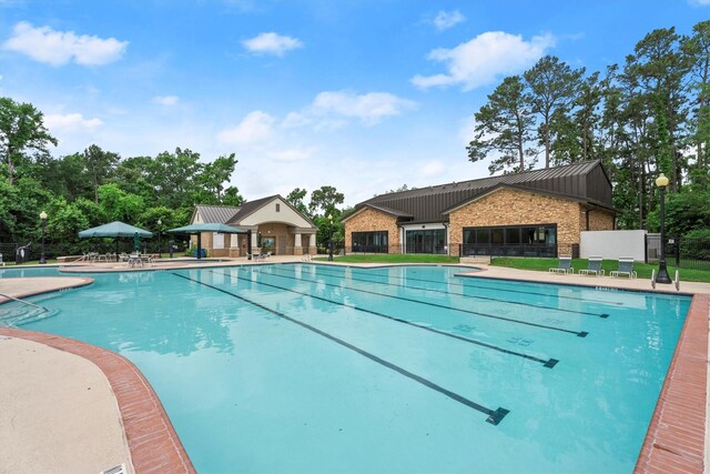 pool with fence and a patio area