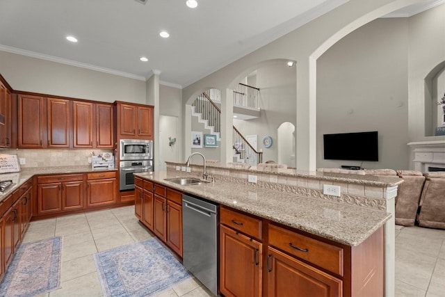 1619 Julia Park Dr, Spring, TX 77386 - kitchen with appliances with stainless steel finishes, a sink, crown molding, light tile patterned flooring, and tasteful backsplash