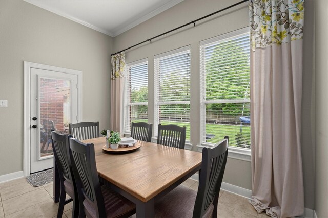 dining room featuring light tile patterned flooring, baseboards, and ornamental molding