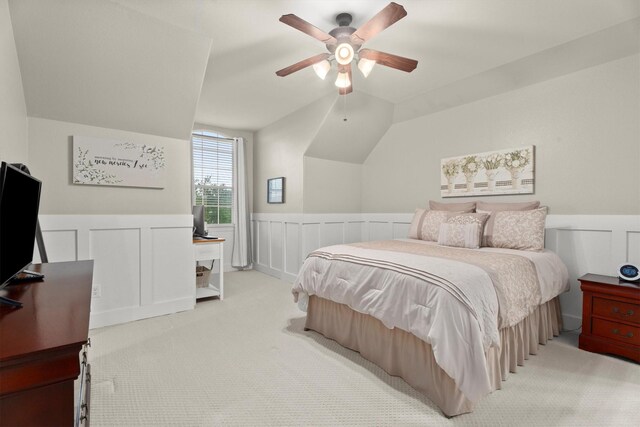 bedroom featuring a wainscoted wall, carpet, and a decorative wall