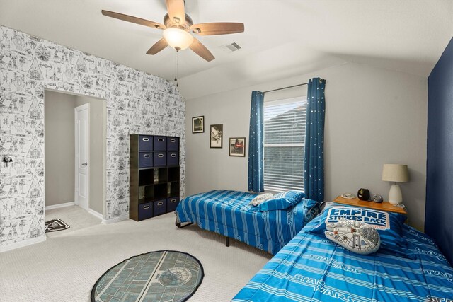 bedroom with ceiling fan, visible vents, vaulted ceiling, baseboards, and carpet flooring