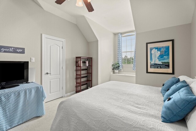 carpeted bedroom with baseboards, a ceiling fan, and lofted ceiling