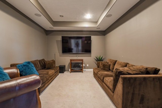 living room featuring recessed lighting, a tray ceiling, baseboards, and carpet floors