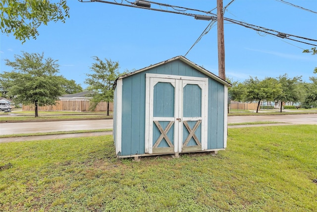 view of shed featuring fence