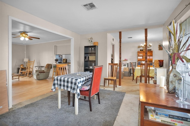 dining area with visible vents and ceiling fan with notable chandelier