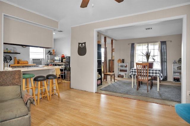 interior space with visible vents, ceiling fan, a wealth of natural light, and light wood-style floors