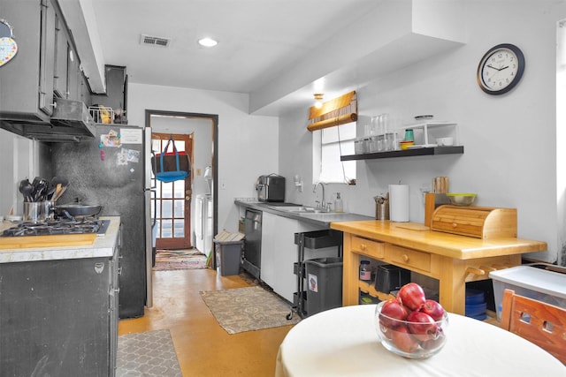 kitchen with open shelves, light countertops, a sink, visible vents, and concrete flooring