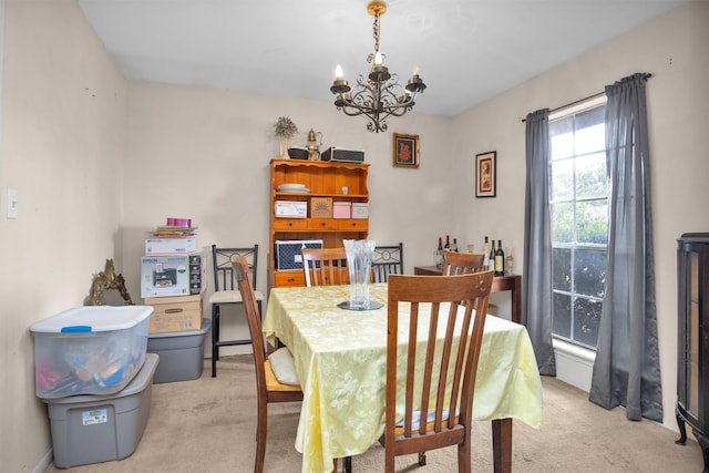 dining space featuring an inviting chandelier and carpet flooring