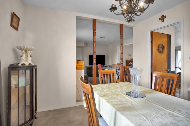 carpeted dining space featuring visible vents, a notable chandelier, and baseboards